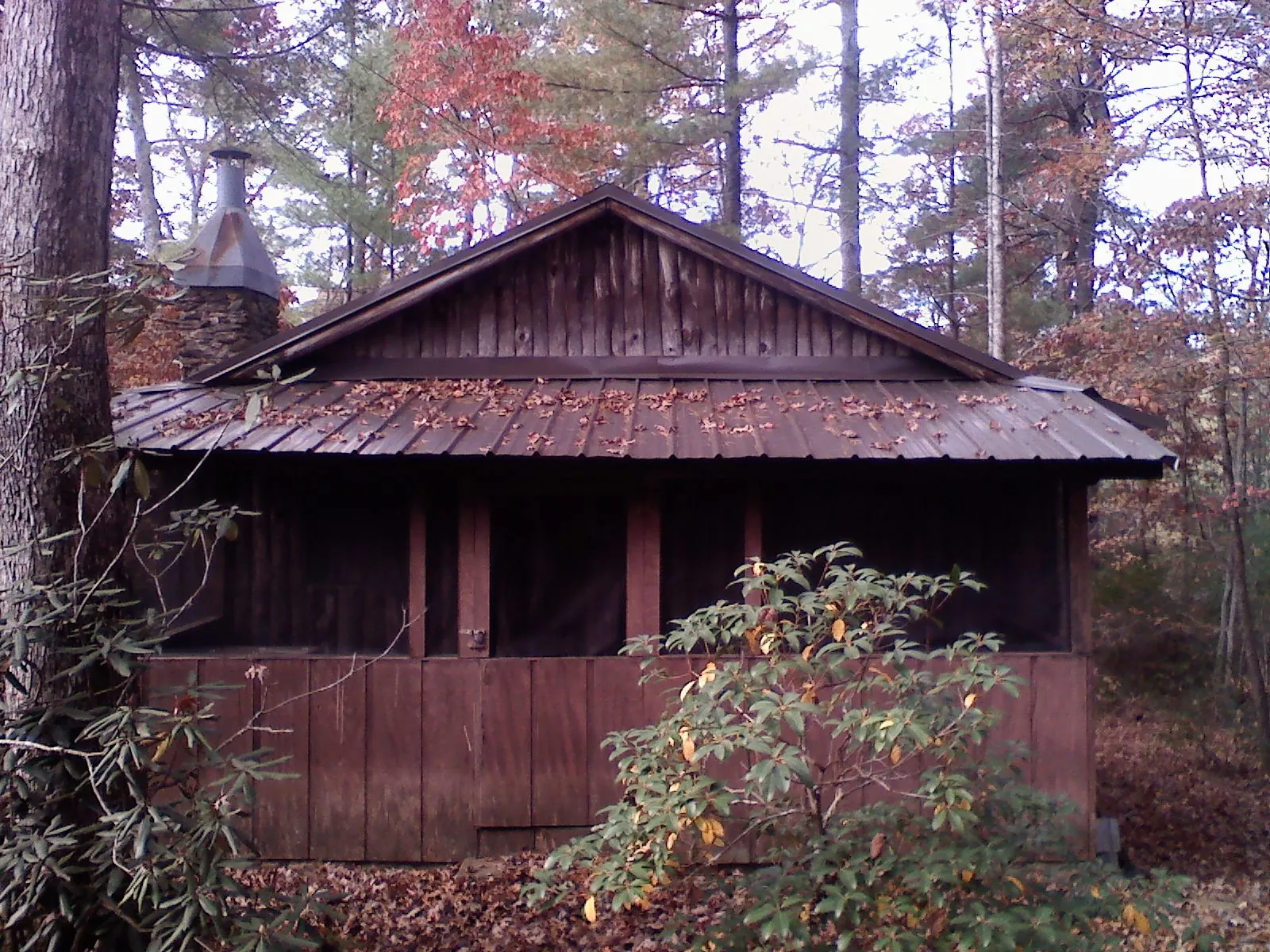 Metal roof over the screened porch of a rustic cabin in Ringgold